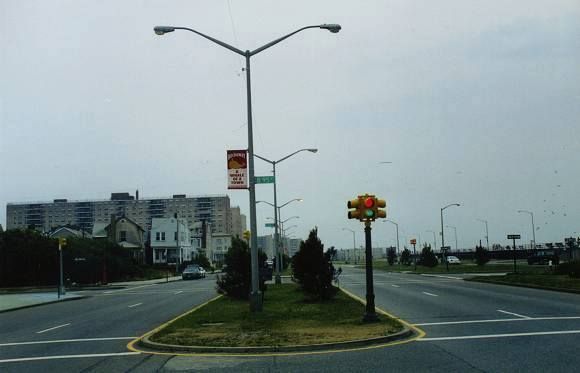 Queens, New York 
In the 2000s, two-section (red and green) traffic signals were scattered in areas of Queens in New York City. One area was the Rockaways. Most were located on Shore Front Pkwy., and I remember I saw many of them there over ten years ago. This picture shows a set-up from there, which was taken by Jeff Saltzman sometime in 2000. 

As time progressed, these traffic signals continued to dwindle, and, in 2006, the last handful were removed from service on Shore Front Pkwy. Alas, the extinction of vehicular red and green heads in throughout New York City.
Keywords: Traffic_Lights