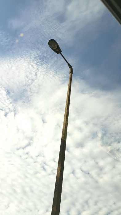 Brown AEL 125 400w HPS streetlight 
Woodforest uses square concrete poles with Davit style arms with Cobra heads, while the Woodlands uses shoe box fixtures with round concrete poles.
Keywords: American_Streetlights