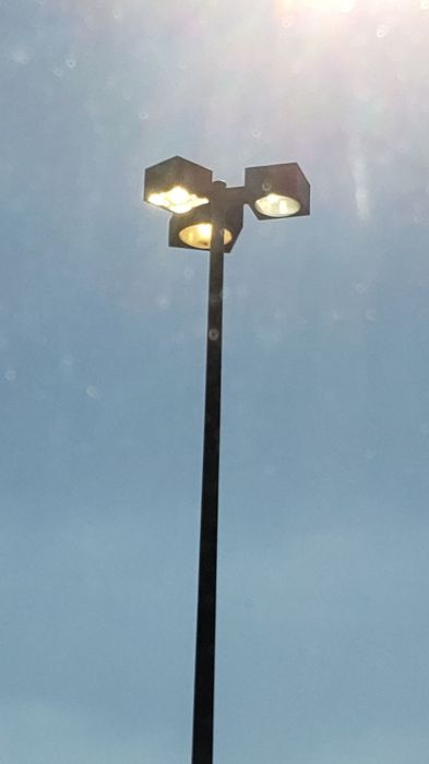dayburning metal halide parking lot fixtures 
Picture taken on Dec. 22, 2019

At the Lowe's parking lot.
Keywords: Lit_Lighting