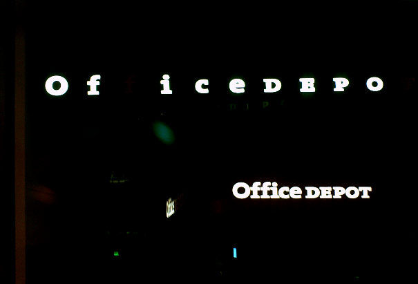 Those Of ice depo - please fix your lights!
The sign is only one sign of bad maintenance in this place. What you can't see is why it is dark below the sign: The front display windows were never used to display anything, but they were lit by a continuous row of F32T8x2 striplights on both sides of the entry door. Those lights burned 24/7 and I watched the tubes burn out one-by-one over the years. They are still powered on right now....all 16 tubes dead with no vacuum, and perhaps the electronic ballasts too.
Keywords: Lit_Lighting