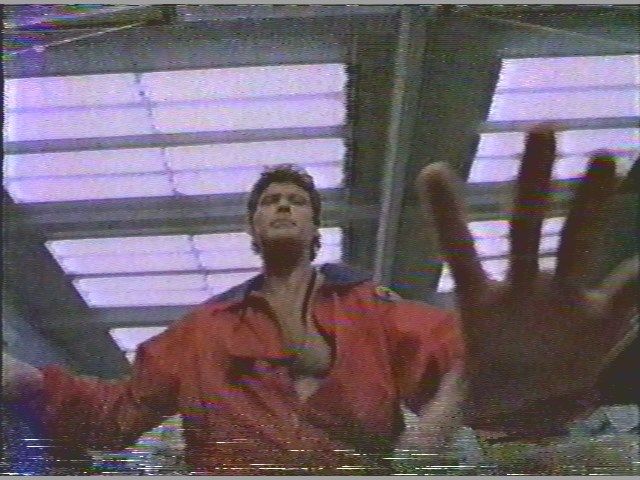 Don't hassle the Hoff with LEDs
I was going thru some old VHS tapes & pulled this frame of David Hasselhoff in "Baywatch." The Lifeguard headquarters building was equipped with this luminous ceiling of T12 wraparounds, most likely to easily provide sufficient light for filming without having to use much if any supplemental lighting. If I remember correctly from the series, there were Lithonia-style T12 four-lamp troffers downstairs, F96T12 slimlines in the garage and one of those plastic Electripak 70w HPS security lights outside at the top front center of the building shining over the beach.
Keywords: Lights_Camera_Action
