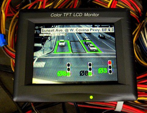 Video Detection
Econolite "RackVision". This monitor is plugged into one of the modules (EB). The green area puts in a call that a car is present, black = no car. Signal icon show current light color.
Keywords: Traffic_Lights