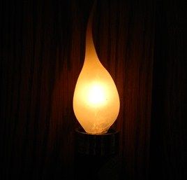 Rubber Covered C-7 Candle Wax Bulb (lit)
A lit silicone rubber covered silicone covered C-7 bulb. These are used in crafts style electric candle lamps that had been available in gift shops and country crafts shops. 1990's,00's vintage, Chinese made.
Keywords: Lit_Lighting