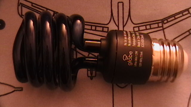 By 13w CFL Black light
A Globe Electric CFL 
It usually has little black patches running down the side of the tube.
Keywords: Lamps