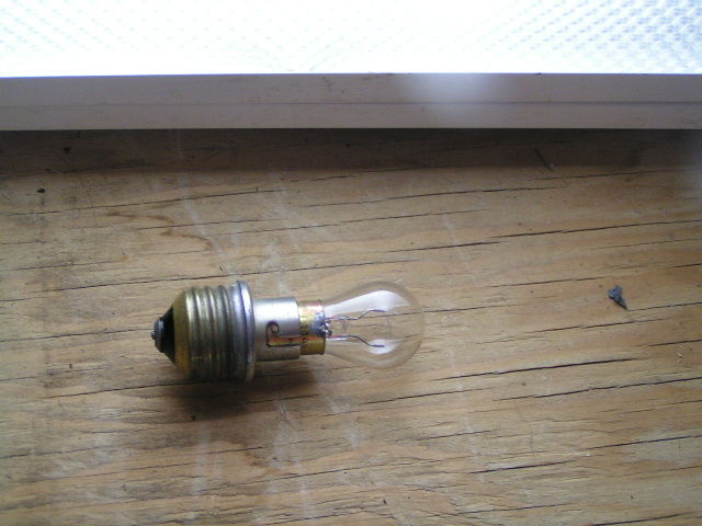 Dunno What you Would Call This...
...but it's a little Edison-Screw-to-bayonet-cap adapter for a tail-light lamp. 
Anyone have any ideas who made this or how old it is?
Keywords: Lamps