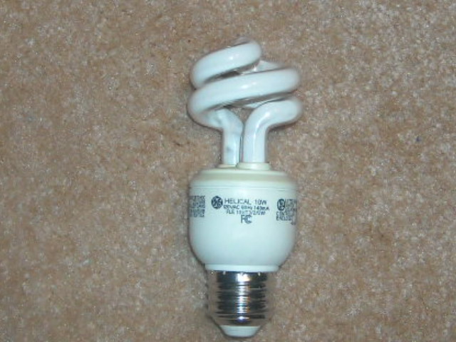  Heavy Used 10w GE Helical CFL
This bulb has been used in an overhead light fixture in my bedroom for around 5 years or so and gets constant use. Seems too work well despite some wear on the phosphor. Have two more in reserve should anything happen to this bulb.
It uses the older programmed start design and takes a few seconds to come on.
Keywords: Lamps