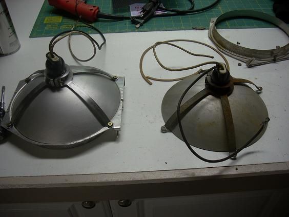 Lancaster Glass Reflector 
Rebuilding the old Glass reflectors. A completed on is on the left, one being worked on is on the right. The frames are all aluminum. The actual reflector dish is mirrored glass. This was before the development of polished aluminum reflectors that were common in signals in the 1950s up till today.
Keywords: Traffic_Lights