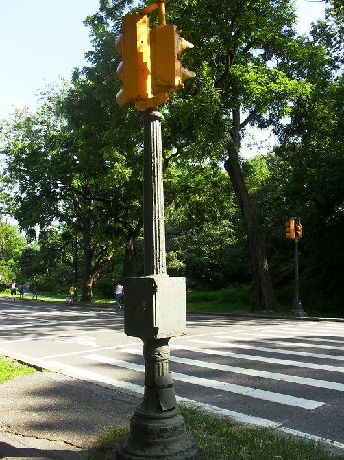 Central Park two-section pedestrian signal (3)
This was an interesting find for me when I first came across the set-up here last Summer. The two-section pedestrian signal was manufactured by the Ruleta company, and it perhaps dates back to the 1930s. 

As of present day, this pedestrian signal still remains in useful service, and it is likely the very last Ruleta red and green set-up in the city of New York.

Also note that it is still connected to its original Union Metal pedestal, and the crosswalk set-up here is still controlled by the original G.E. signal controller (as shown in the picture) as well. Aside from these, a handful of other U.M. pedestals and G.E. signal controllers still remain in existence in other areas of Central Park.
Keywords: Traffic_Lights