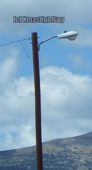 StreetLight #212
Ofcourse a common fixture, but it was there & I had the camera in my hand :) 
Does look nice on this pole/setup to me though.
(image was taken out the car window)

Location:
Fairplay, CO
Keywords: American_Streetlights