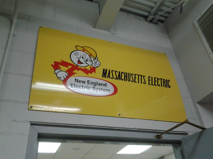 National Grid Training Facility: Old NEES/Mass Electric Sign!
National Grid came to the US from the UK in the very late 90s. They had bought out New England Electric System (NEES), which was planning on buying neighboring utility Eastern Utilities Associates (EUA). National Grid consumed both parent companies, effectively taking full control of the electric distribution in Rhode Island and southeastern Massachusetts. They also have territory in upstate NY in the Buffalo area and have some lines (I think transmission) on Long Island, NY. 

This was NEES's mascot, Reddy Kilowatt. Cool looking fella. A light bulb nose, a wall socket for an ear, his body is a bolt of electricity. This sign is in mint condition too. Must not have ever seen use outside.

NEES's Rhode Island branch was called Narragansett Electric [url=http://www.ebay.com/itm/PORCELAIN-REDDY-KILOWATT-NARRAGANSETT-NEW-ENGLAND-SYSTEM-ELECTRIC-RHODE-ISLAND-/282258380809?hash=item41b7e91809:g:OKIAAOSwB09YLND0] and here's their version of this sign, just to show you how much these signs go for. [/url]

[url=http://www.ebay.com/itm/Reddy-Kilowatt-Massachusetts-Electric-HUGE-porcelain-enamel-sign-4-by-29-1-2/291730360109?_trksid=p2047675.c100009.m1982&_trkparms=aid%3D888007&algo%3DDISC.MBE&ao%3D1&asc%3D41375&meid%3D8bd2736546fd4e66a20fbf5e80adc3a9&pid%3D100009&rk%3D1&rkt%3D1&sd%3D282258380809] I also found a Mass Electric version for sale. [/url]
Keywords: Miscellaneous