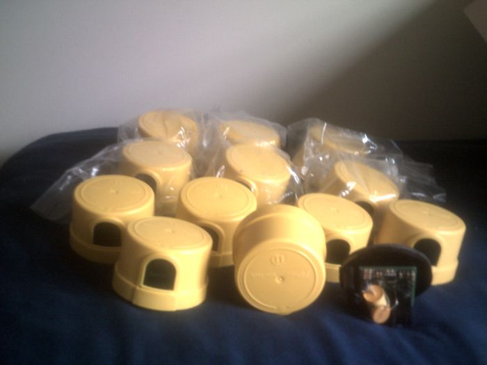 Stash of NOS 2011 FPolc Sun-Tech Photocells
From Ryan (thanks!). Here we have one dozen 480V yellow Sun-Tech PCs. Here's the awesome part: they all work on 120V! (Well the six in the plastic I did not test, but they're all identical and the six out of the plastic tested just fine). One is opened up and the cover is on its side for viewing purposes. Very sensitive PCs too. They must be 1.0ftc.

The opened one acts a little funny. Initially, it would shut off as normal and then come back on, even in broad daylight. Then I was able to get it working, but I noticed that it will only work once (it'll shut off and remain off until "dusk" and then at "dawn" it will remain on and become a dayburner until power is shut off and turned back on. then it will work for one cycle and dayburn again. Weird...

I wonder if that is the typical fail mode of those faulty Sun-Techs? For them to work for one cycle and then dayburn? Maybe that's why there were so many dayburners, as they weren't getting detected? IDK lol.
Keywords: Gear