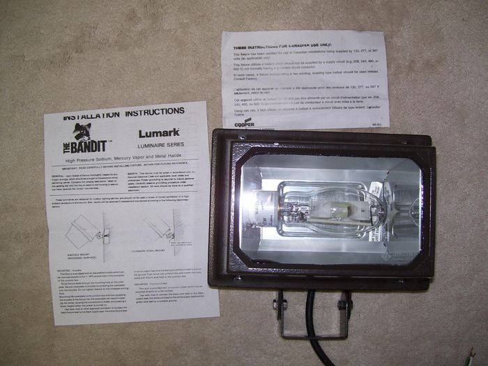Lumark Bandit MH Flood 
Here's a [url=https://dl.dropboxusercontent.com/u/102661519/Lighting/Catalogues/lumark_bandit.pdf]Lumark Bandit[/url] floodlight that I got at Home Depot on clearance today. This one uses 175w MH lamps but the [url=http://www.galleryoflights.org/mb/gallery/displayimage.php?pos=-4954]ballast[/url] (made by Advance) can also run 175w MV lamps too but finding the cram 175w MV lamp might be a bit difficult. This flood looks pretty well built and is kind of heavy for a fixture of this size. 

[url=http://a.imageshack.us/img706/8028/1001863v.jpg] Click here to see the fixture lit[/url]
Keywords: American_Streetlights