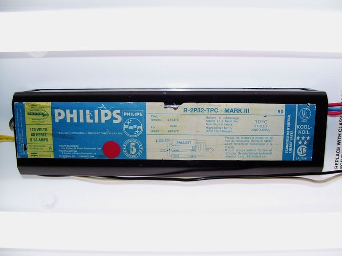 Philips F32T8 Ballast
Here's a older Canadian Philips F32T8 magnetic rapid start ballast that seems to be a Canadian version of a Advance Mark 3 ballast shown here installed in a modern wraparound fixture with two Philips F32T8 natural sunshine lamps.  
Keywords: Gear