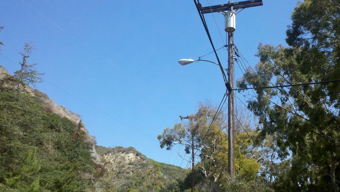 Uh oh a battle? 
Here's a boundary between two different utilities. The light in foreground belongs to San Diego Gas & Electric. Their service area terminates at this pole, while another power line takes over, belonging to Southern California Edison. The SCE light is on the next pole. Located in southern Laguna Beach, CA.
Keywords: American_Streetlights