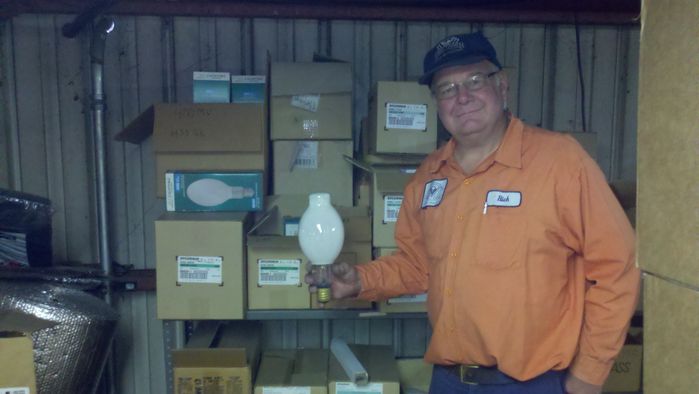 The man of the shop
Here's rlshieldjr holding an '82 vintage NOS Sylvania H33GL-400/DX lamp. This section is full of different lamps, some as high as 2000w for ballfield lighting. Besides the '82 Sylvania, there are also a few '77 Westy H39KC-175/DX full framers in storage.
Keywords: Miscellaneous