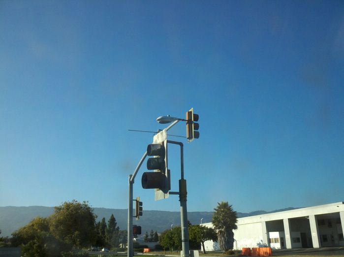 Weird traffic signal/street light set up
See the cobrahead mounted on the traffic signal mastarm behind the signal head? Normally the cobrahead safety light is mounted on a separate mastarm on top of the traffic light. This is in the vincity of the Santa Barbara Airport in Goleta, so that is prolly the reason. Located on Hollister Ave in Goleta.
Keywords: American_Streetlights