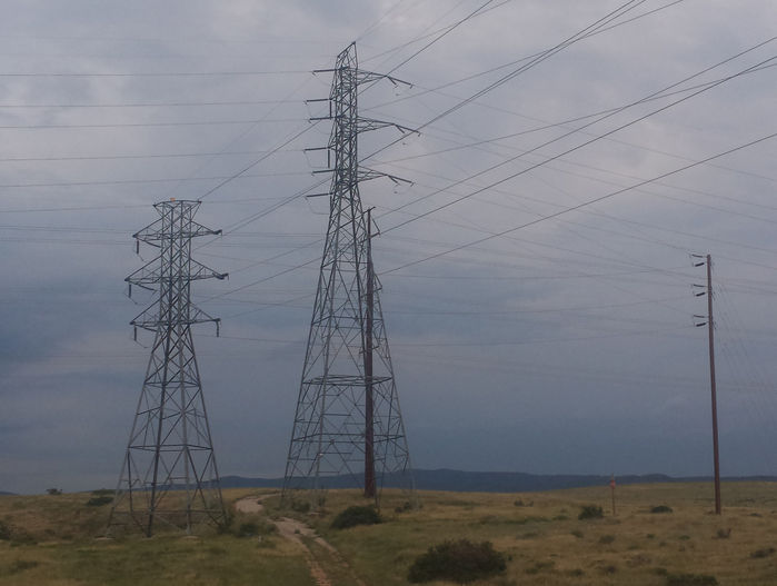 Another angle of the separation.
As you see, the 115 KV circuit goes along to the west, going onto those big lattice towers, and the 240 KV circuit goes to the east.

The 115 KV lattice tower there on the left has some lose insulators wrapped against the tower, as the de-energized wires just dead ends right there, and the energized wires go underneath the 240 KV circuit wires to a single wooden pole directing the circuit to the big lattice tower in the middle, and directing it to the west, going along with the big lattice towers made for dual 240 KV circuits. (So one side is a 240 KV circuit and the other side is a 115 KV circuit, if you understand what I mean)
Keywords: Miscellaneous