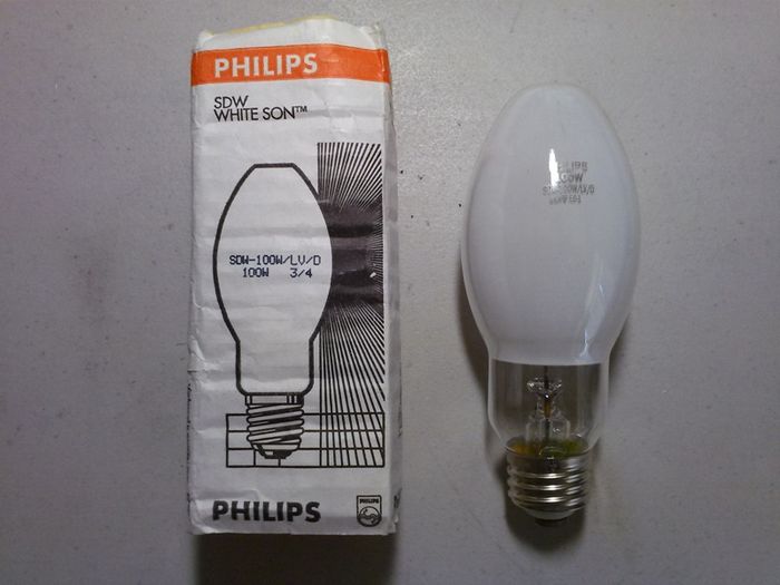 Philips SDW "White SON" LV
I finally got myself one of these obscure things. This is a low voltage (55 volt arc tube) version of the European Philips SDW White Son high pressure sodium lamps in a medium based E21 format that was aimed for the US market. Even so, these lamps did not become very popular here in the US.

It requires an ANSI S-105 hybrid magnetic/electronic ballast to operated correctly. I've tried it on a regular S-54 100 watt high pressure sodium ballast and it works but lights up the usual HPS orange instead of the incandescent-like white color it is supposed to be.
Keywords: Lamps