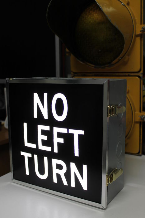 NO LEFT TURN
Here's my latest project, a mini version of the old style backlit NO LEFT TURN signs that were common at intersections in the GTA back in the 70s and the 80s. They were killed off by reflective aluminium symbol signs. The real ones were double the size of my homemade one and had a yellow casing instead of grey. They also had a short visor. 

I made this from a 10" pull box, a custom aluminium frame made from aluminium channel and a fluorescent fixture diffuser that I stenciled and painted. A ballast assembly from a two lamp PL-13 fixture provides the light. 

Here's a shot of it opened up. I tried to replicate how the real ones open up so the sign panel is on a little door instead of slide in. It probably would have been easier to make the panel slide in a slot instead of a door lol. 
[url=http://i.imgur.com/Spzd7QS.jpg][img]http://i.imgur.com/HKzmQCJ.jpg[/img][/url] 
Lamps inside are Philips PL-13/841.
Keywords: Misc_Fixtures