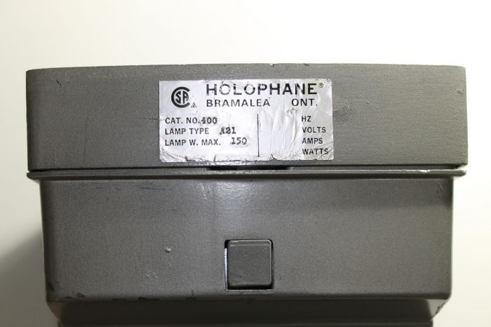Holophane Wallpack - Tag and fixture latch
Even those this a simple incandescent wallpack, I was pleasantly surprised that it had a latch on refractor door instead of a screw on one like the newer tallpacks. Anyway you can also see that fixture tag. It seems like Holophane used to have a plant in Bramalea, now a part of Brampton.  
Keywords: American_Streetlights