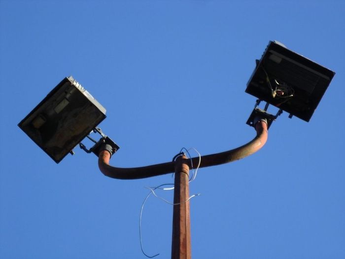 Sad Floods :(
A pair of neglected Stonco 'Maxi-Flood' flood lights in a parking lot with missing glass,one without a reflector,no lamps and wires hanging.
Keywords: American_Streetlights