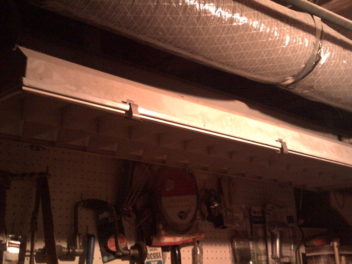 F90T17!!!!!
I promise you I'd get a picture! Here it is! I'm sorry it wasn't the best quality, but the new AC duct was blocking the fixture. This thing is about 62" by 18". The ballast, I'm assuming is GE, like the other one at my great-aunt's house. This one only has one lamp and starter installed, because he didn't need two 90w lamps over his desk. This is mounted roughly 5 feet off the ground. Can someone please date this? thinks.
