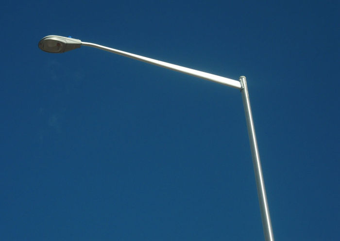 GE-look-alike induction fixture.
This was found on I-25 on a parking ride on the exit to loveland. US Highway 35 I think.

Any idea the make? There are a BUNCH like this in the parking lot. Most on Tapered-E arms but some on upsweeps.
Keywords: American_Streetlights