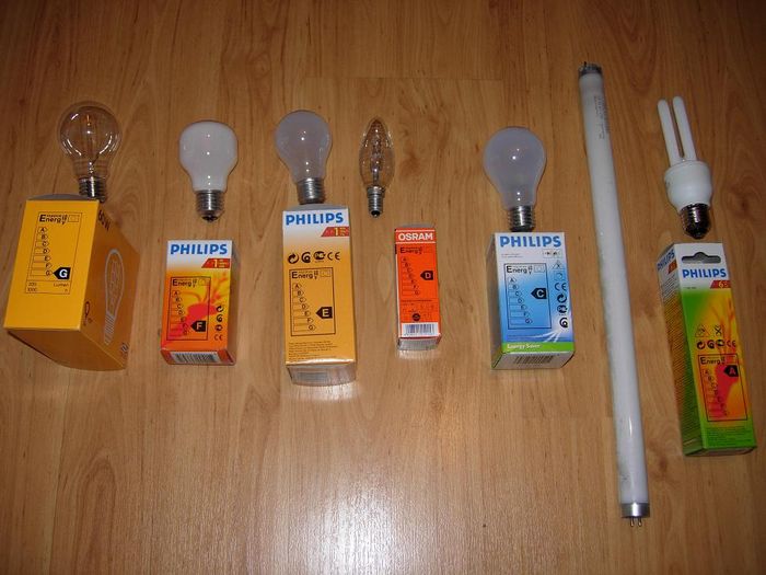 Lamps arranged by EU energy efficiency rating!
Left to right:
Ikea decorative 60 W (banned?)
Philips soft yellowish 40 W (bannned)
Philips 100 W  (banned)
Osram 28 W halogen (will be banned)
Philips 42 W halogen (banned because it's frosted, clear version will be banned soon)
NARVA 15 W halophosphate fluorescent tube. Don't have the packaging, but I think it would be B-class. (banned)
Philips 11 W CFL, Only lamp here that isn't/won't be banned!
Keywords: Lamps