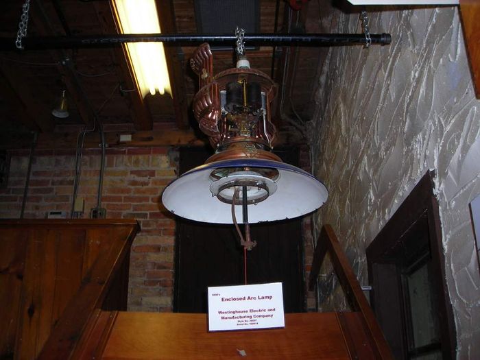 1890's Westinghouse Enclosed Carbon Arc Lamp
Here's a shot of a old Westinghouse enclosed arc lamp with the cover opened showing the control gear inside. Note that the glass globe around the carbon rods is missing. 
Keywords: Lighting_History