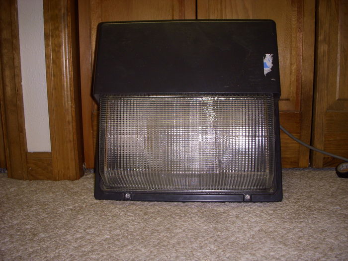 My new Lithonia 400 watt Wallpack!
Got this at the RE-Store again, I saw this there months ago, looks like it never got bought, and it was never even USED either! It's like new-old-stock that I found there, Looks like it has never seen a day in service.

Ballast was originally a 400 watt HPS but the ballast was 277 volt single tap soo... I converted this to Metal Halide with that extra ballast I Had laying around, surprisingly the metal halide lamp fits in there! It's really bright too.

The refractor is glass, make the thing heavy.

I will take a pic of it lit later, and open too.
Keywords: Misc_Fixtures