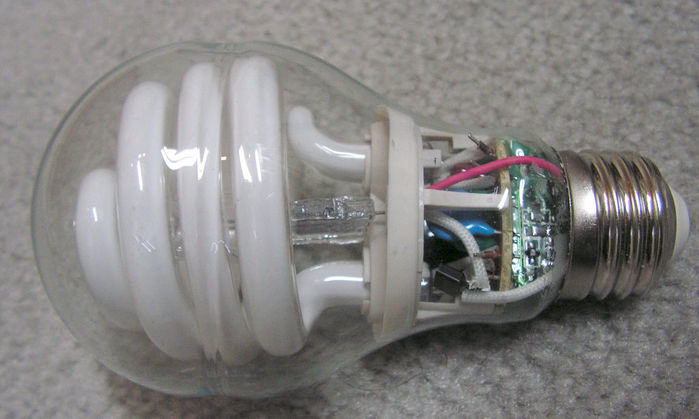 GE Hybrid CFL
I only purchased this lamp because of its interesting construction, and promptly scraped off all of its coating so the insides were easily viewable. This design uses a 120v, 60w halogen capsule in the middle of the spiral to provide higher brightness while the amalgam vaporises in the fluorescent tube. The lamp draws about 70w with the capsule on, and in just under a minute, a timer switches the halogen lamp off (unless lamp is hot, in which case, the halogen lamp only comes on for a second). There is a noticeable drop in brightness and colour shift when the halogen lamp turns off.
Keywords: Lamps