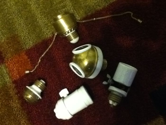 Antique Electrical stuff!!!!
(sorry for low quality it's my iPod camera, my camera is getting a replacement lens)

In the picture you see:
-dimmer socket adapter
-adjustable angle socket adaptor
-2 socket adapter (I polished the brass)
-all ceramic socket (except for the shell and contacts of course)
-old Edison based "plug" (instead of the 2 prong plug)  
Keywords: Lighting_History