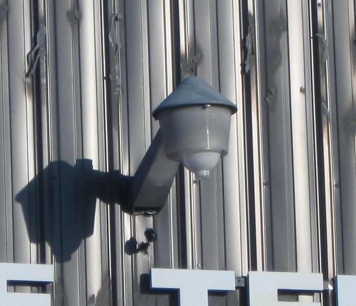 Yikes! 
I guess someone thought it would be a good idea to put a 1KW MV lamp in this much smaller fixture, I have to disagree! 
Keywords: American_Streetlights