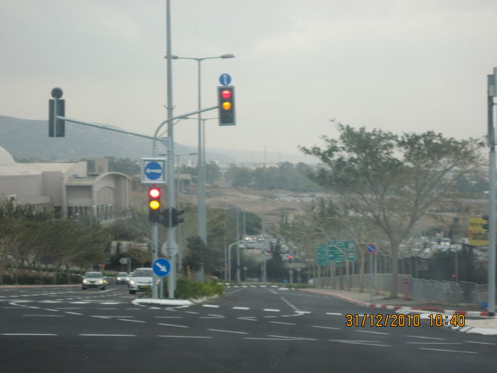LED traffic lights near Castra mall, Haifa city
One of them have a new type of road arrow sign, which is larger then the normal road arrow signs on our traffic lights.
The traffic lights themselves are 12-12-12 and the pedestrian ones are 8-8.
Their LED signals are made by S.C.A.E and imported by Hasmal Habarak company. They have a polycarbonate lens that prevents reflection of sunlight at the morning and the evening.
They are in the both red and orange mode, means that you should be ready for drive, before the traffic light changes to green (This traffic light mode aren't exist in North America, where the traffic lights changes from red to green instantly).
Keywords: Traffic_Lights