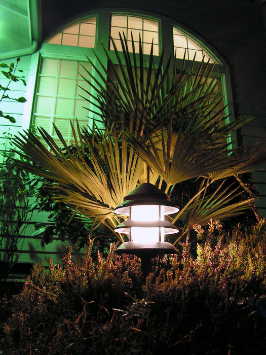 Malibu tier landscape light with LED retrofit
I installed these in 2004 and retrofitted them with [url=http://www.galleryoflights.org/mb/gallery/displayimage.php?pos=-7803]Philips AccentLED capsules[/url] in 2010. These are the older style lights, no longer made, but are the exact lights shown in the picture on the box for the AccentLED lamps, so I figured they'd be worth a try. They are a perfect fit, and give a better light distribution than the 7w low-voltage incandescents originally equipped. Uplighting the palm tree behind it are two 10w halogen spots and behind that, a 100w mercury wall pack with clear bulb.
Keywords: Misc_Fixtures