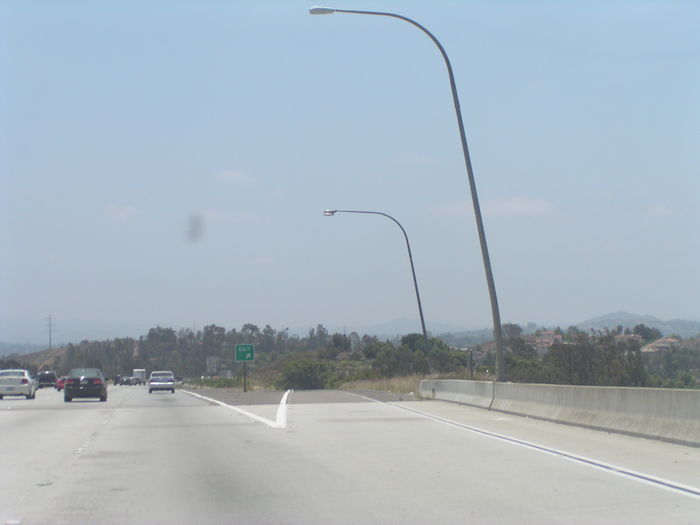Very cool leaning davit poles on I-15
I-15 in San Diego County is full of these light poles. Most have either LPS or HPS full cutoffs. However look at the second pole in this pic, it still has its original GE M-1000 700w merc light from '77.
Keywords: American_Streetlights