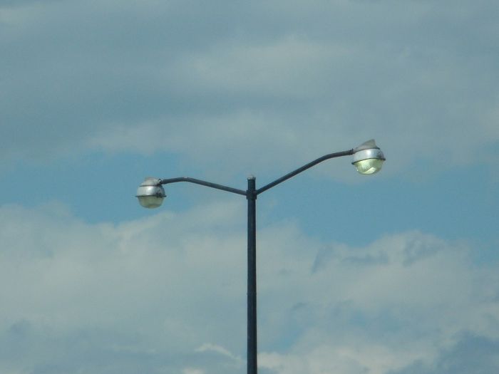First Generation LM Ovalites
Here's a pic of two first generation Line Materials Ovalites lighting a parking lot. One of the lights is dayburning while I guess the other one has a dead lamp inside.  The ballasts are mounted in a transformer base so there's no visible ballast cans on the pole.  


Keywords: American_Streetlights