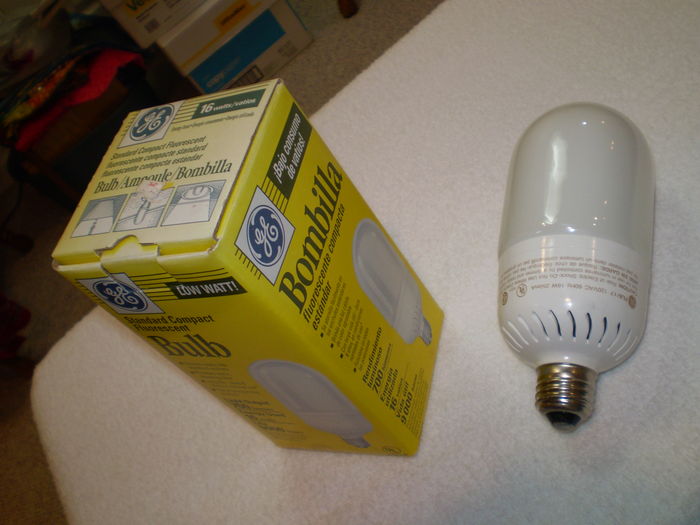 General Electric Standard Compact Fluorescent Bulb
Here I found this at Shallowford True Value hardware store at Marietta, Ga the oldest CFL I bought.  There is a date stamp on the base of the bulb saying 95-07 twice.  This beast is heavy with real glass outer envelope with double folded U bent bulb inside probably powered by real magentic ballast.

Light Output: 700 Lumens
Lamp Life: 9000 Hours
Base: [Medium] (one-inch) Edison Screw (E26)
Fabrication Date: July 1995 (stamp on base)
Fabrication Location: Taiwan
Voltage: 120 Volts 60 Hz
Current: 250 mA
Ballast: Magentic Integral
Keywords: Lamps