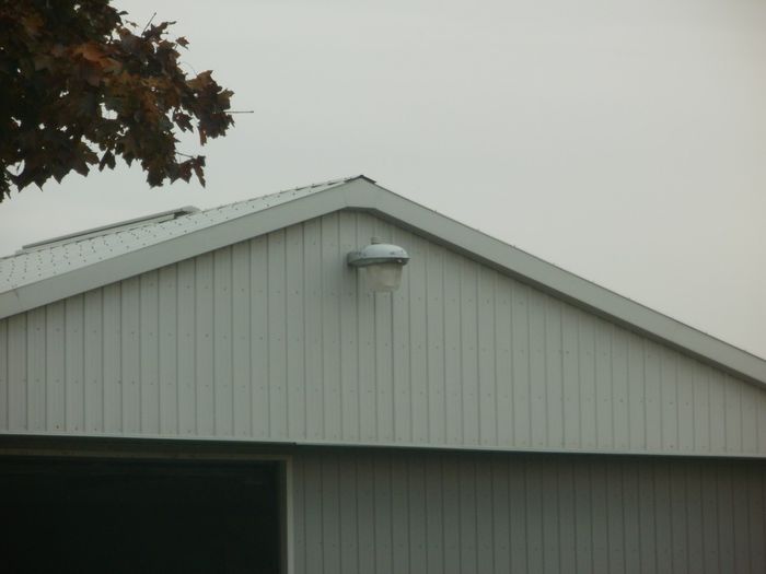 GE Crimefighter 
Here's a GE M-250 Crimefighter cobrahead mounted on a farm building, I haven't seen it at night so I don't know what light source it uses or if it works or not. 
Keywords: American_Streetlights