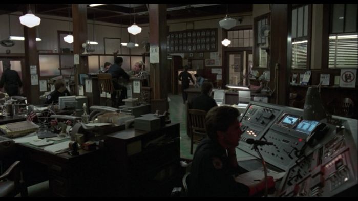 Robocop (1987) 0:29:37
The police dept office. Police Officers gets to see Robocop for the first time here. Lots of old school incandescent lights with a few fluorescent strips here and there.
Keywords: Lit_Lighting