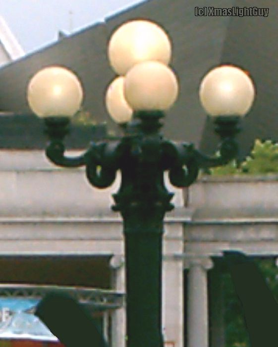 StreetLight #009 - 5-Lamp MV 'Streetlight'
This one's NOT mine, it's at a park downtown in the nearest large city (and is probably fairly old too). They're used to light sidewalk/patio areas.

I'm pretty sure these are Mercury Vapor since one of them was dayburning (all 5 lamps) and looked MV in color 

Thought these were a pretty cool looking fixture (and i had the camera with me anyway) so i took a pic of a couple 
Keywords: American_Streetlights