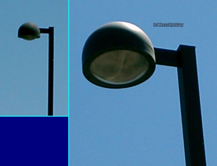StreetLight #018 - Parking Lot Streetlight At A Middle School
This one is a streetlight in a local  middle school's parking lot.
I kinda like the rounded/bowl shape of it :)

(don't remember if these are MH or HPS as its been quite a while since I've been by there at night)
Keywords: American_Streetlights