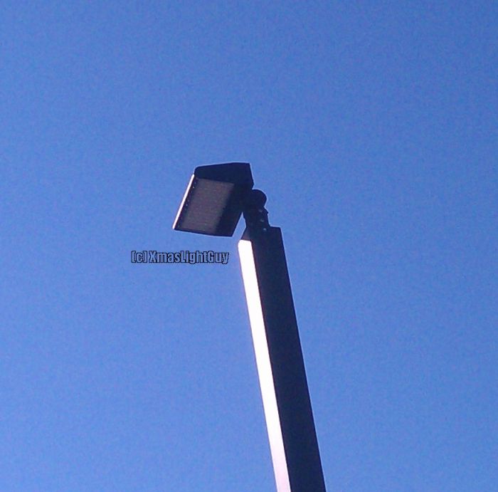StreetLight #287 - Little LED thing.
LED replacement in a parkinglot..to me the little things look a bit dumb on those poles .lol.
Former fixtures were standard-looking shoeboxes (don't have a pic of 'em).


Location:
'Bowles Crossing' shopping center. CO
Keywords: American_Streetlights