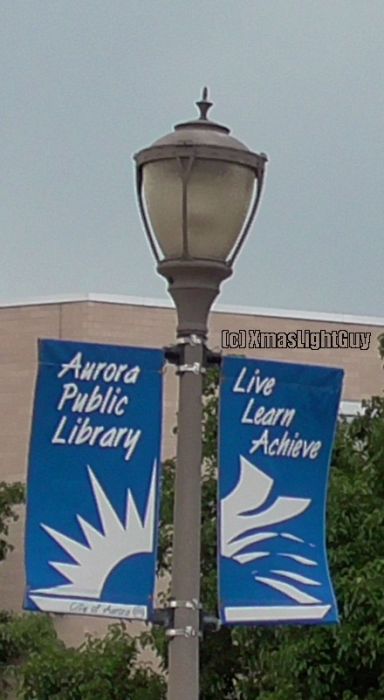  StreetLight #339 
Fairly nice looking post-top type fixture. I've seen other similar ones, generally in black.
Don't know what type of lamp since I didn't see these lit.


Location:
Aurora Municipal Center/Aurora Public Library, Aurora, CO

Keywords: American_Streetlights