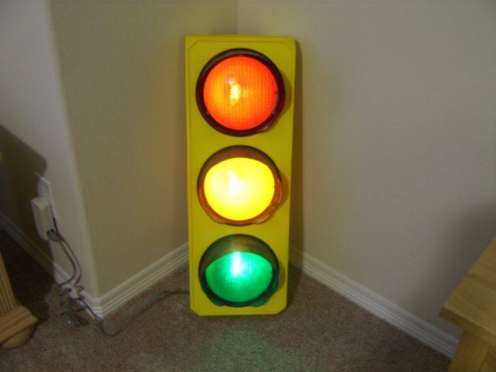 My Traffic Light
This I brought from the restore. Once I got it it had no bulbs. So what I did, I put two 4w incandescent night light bulbs for the red and yellow light, and a green LED night light bulb for the green light. Its housing is plastic, with the color yellow on the body, and black visors. 
Keywords: Traffic_Lights