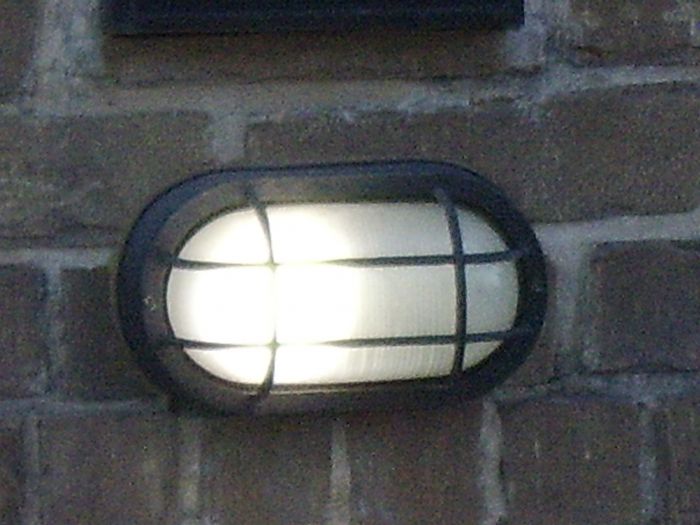 A wall fixture, with a cool white bulb inside.
I don't know if its a LED bulb, but this fixture lights up the street, unlike the down facing wall fixtures, that only light up the house number. Plus, being able to light up the street, it seems to be a miniature streetlight!
Keywords: Lit_Lighting