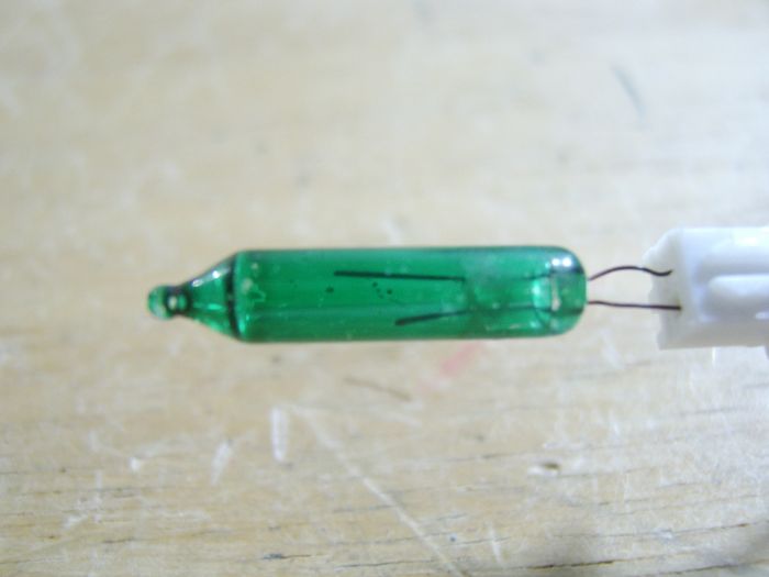 green 2.5v incandescent Christmas light replacement mini bulb
Found it in a my stash of Christmas light bulbs drawer.
Keywords: Lamps