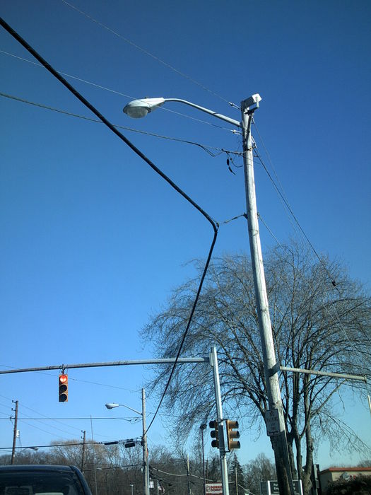 M-400A2 Looking at the Tacky Phone Line Set-Up
LOL, it's looking down at  how the phone line is rigged to the pole. I guess when this pole was installed it was installed a little farther back than the old one and the phone line wouldn't reach?
Keywords: American_Streetlights