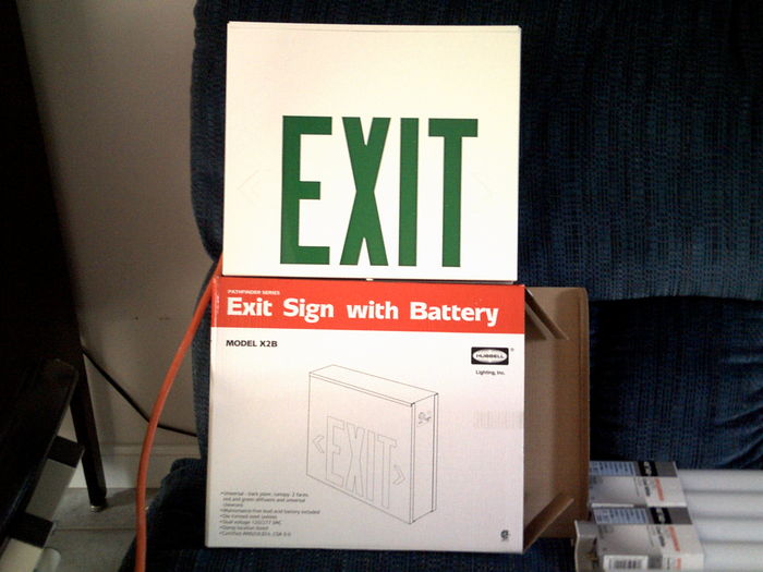 My first Exit Sign
A Hubbel incandescent in it's sealed package (well not anymore lol). It was boxed wearing it's red panels but it came with green panels. It was also boxed wearing both "EXIT" faces but came with a black face with knockouts for wall mounting. It also came with a bracket so it can be mounted from a ceiling or stick out from a wall. Right now it's mounted the latter on an extra scrap of wood i found in the shed that was left over from when our deck was extended.
Keywords: Miscellaneous