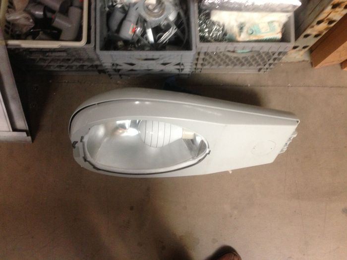 Induction street light at Restore!
Here is a shell of an AEL 125 with a Philips QL 165w lamp and gear installed. I didn't buy it because the price would give ya a heart attack, it is $100! Also it is 208v so I can't light it easily. The plastic under the induction lamp base looks yellowed so it is obviously used. The lamp can be removed with a half twist, gonna remove it carefully so to not damage the long exhaust tube. The exhaust tube has a piece of long metal that receives the electrons from the copper windings that surround the tube when the lamp is installed. i suppose it is called the antenna. The driver unit is pretty small, like 3 inches wide and 5 inches long. The fixture feels pretty light without the heavy magnetic ballast found in HID versions!
Keywords: American_Streetlights
